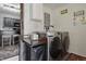 Bright laundry room with modern washer and dryer, utility sink, and plenty of storage at 443 S Arlington Ave, Indianapolis, IN 46219