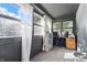 Bright sunroom with large windows, neutral carpet and built in desk area at 443 S Arlington Ave, Indianapolis, IN 46219