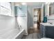 Full bathroom featuring white tiled walls, modern vanity, and neutral colored flooring at 4849 Central Ave, Indianapolis, IN 46205