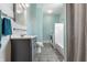 Well-lit full bathroom with modern gray vanity, shower-tub, and in-unit washer and dryer at 4849 Central Ave, Indianapolis, IN 46205