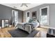 Bright bedroom with hardwood floors, neutral walls, ceiling fan and abundant natural light through many windows at 4849 Central Ave, Indianapolis, IN 46205