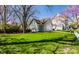 Beautiful home exterior featuring a well-manicured lawn, garage, and mature trees at 4849 Central Ave, Indianapolis, IN 46205
