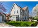 Charming two-story home with neutral siding, well-maintained lawn, and mature trees at 4849 Central Ave, Indianapolis, IN 46205