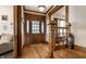 Inviting foyer with hardwood floors, wood trim, decorative staircase, and a vintage fire extinguisher at 4849 Central Ave, Indianapolis, IN 46205