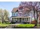 Beautiful two-story home with a classic facade, front porch, lush lawn, and inviting curb appeal at 4849 Central Ave, Indianapolis, IN 46205