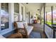 Cozy front porch featuring comfortable wicker furniture, a ceiling fan, and views of the surrounding neighborhood at 4849 Central Ave, Indianapolis, IN 46205