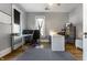 Office with hardwood floors and built-in desk space with multiple monitors at 4849 Central Ave, Indianapolis, IN 46205