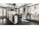 Modern kitchen features stainless steel appliances, a breakfast bar, and bright white cabinets at 4849 Central Ave, Indianapolis, IN 46205
