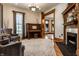 Elegant living room featuring a fireplace, piano, and detailed wood trim at 4849 Central Ave, Indianapolis, IN 46205