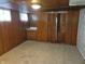 Finished basement featuring paneled walls, carpeted floor, and built-in cabinet at 509 E Columbus St, Martinsville, IN 46151