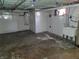 Unfinished basement featuring painted walls and ceiling, mechanicals, and utility sink at 509 E Columbus St, Martinsville, IN 46151