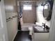 Well-lit bathroom featuring a sink, toilet, tub and shower combination at 509 E Columbus St, Martinsville, IN 46151