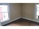 Bright bedroom featuring two windows, white trim, neutral walls, and hardwood floors at 509 E Columbus St, Martinsville, IN 46151