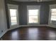 Bright bedroom featuring three windows with wood flooring at 509 E Columbus St, Martinsville, IN 46151