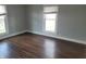 Bright bedroom featuring windows, white trim, neutral walls, and hardwood floors at 509 E Columbus St, Martinsville, IN 46151
