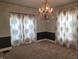 Bright dining room featuring a chandelier and decorative curtains at 509 E Columbus St, Martinsville, IN 46151