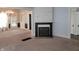 Spacious living room featuring a decorative fireplace, chandelier, and bright, natural light at 509 E Columbus St, Martinsville, IN 46151