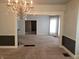 Living room featuring a decorative chandelier and neutral paint at 509 E Columbus St, Martinsville, IN 46151