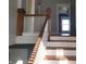 Staircase featuring wood accents and a white railing at 509 E Columbus St, Martinsville, IN 46151