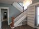 Bright staircase featuring a wood banister, white railings and an adjacent built-in at 509 E Columbus St, Martinsville, IN 46151
