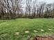 Expansive backyard featuring mature trees and a trampoline, great for recreation at 5814 Lakefield Dr, Indianapolis, IN 46254