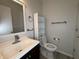 Half bathroom featuring a dark vanity with a light countertop, toilet, and modern flooring at 5814 Lakefield Dr, Indianapolis, IN 46254