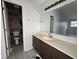 Bathroom featuring a dark vanity with a light countertop and modern flooring at 5814 Lakefield Dr, Indianapolis, IN 46254