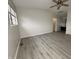 Open bedroom featuring modern flooring, ceiling fan and a window providing natural light at 5814 Lakefield Dr, Indianapolis, IN 46254