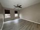 Spacious bedroom with two windows, modern ceiling fan, and wood-look flooring at 5814 Lakefield Dr, Indianapolis, IN 46254
