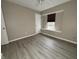 Bedroom featuring neutral walls, wood-look floors, and a window at 5814 Lakefield Dr, Indianapolis, IN 46254