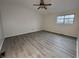 Spacious bedroom with modern flooring, ceiling fan and a window providing natural light at 5814 Lakefield Dr, Indianapolis, IN 46254