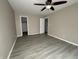 Bedroom featuring a ceiling fan, wood-look floors, and access to the closet at 5814 Lakefield Dr, Indianapolis, IN 46254