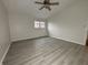 Bright bedroom featuring modern flooring, ceiling fan and a window providing natural light at 5814 Lakefield Dr, Indianapolis, IN 46254