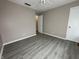 Bedroom with neutral walls, wood-look floors, ceiling fan, and white trim at 5814 Lakefield Dr, Indianapolis, IN 46254