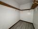 View of a closet with white walls, wood trim and gray flooring at 5814 Lakefield Dr, Indianapolis, IN 46254