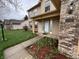 Inviting front porch with brick accents, manicured flower beds, and a well-lit entrance at 5814 Lakefield Dr, Indianapolis, IN 46254