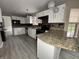Well lit kitchen featuring granite countertops, white cabinetry, and stainless steel appliances at 5814 Lakefield Dr, Indianapolis, IN 46254