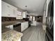 Modern kitchen with granite countertops, white cabinetry, and stainless steel appliances at 5814 Lakefield Dr, Indianapolis, IN 46254