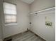 Laundry room with gray walls, wood-look flooring, a window and hookups for appliances at 5814 Lakefield Dr, Indianapolis, IN 46254