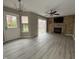 Open living room featuring modern flooring, sliding door, and fireplace with brick accent wall at 5814 Lakefield Dr, Indianapolis, IN 46254