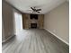 Large living room featuring modern flooring, sliding door, fireplace with brick accent wall, and ceiling fan at 5814 Lakefield Dr, Indianapolis, IN 46254