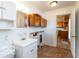 Full bathroom featuring a white vanity, wood cabinets, a mirror, and tile floor at 5838 W Henry St, Indianapolis, IN 46241