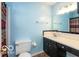 Colorful bathroom featuring a light blue painted walls, vanity, and toilet at 5838 W Henry St, Indianapolis, IN 46241