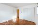 Empty bedroom showcasing hardwood floors, neutral walls, closet, and a window at 5838 W Henry St, Indianapolis, IN 46241