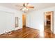Bedroom with hardwood floors, closet, ceiling fan, and neutral paint at 5838 W Henry St, Indianapolis, IN 46241