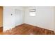 Bedroom featuring hardwood floors, neutral walls, closet, and a window with blinds at 5838 W Henry St, Indianapolis, IN 46241