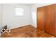 Cozy bedroom with hardwood floors and a bright window providing natural light at 5838 W Henry St, Indianapolis, IN 46241