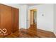 Bedroom featuring hardwood floors, closet and view into the en suite bathroom at 5838 W Henry St, Indianapolis, IN 46241