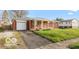 A cozy single-story house with a front-facing garage and a well-kept front lawn at 5838 W Henry St, Indianapolis, IN 46241