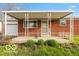 Charming front porch with a brick exterior and green lawn at 5838 W Henry St, Indianapolis, IN 46241